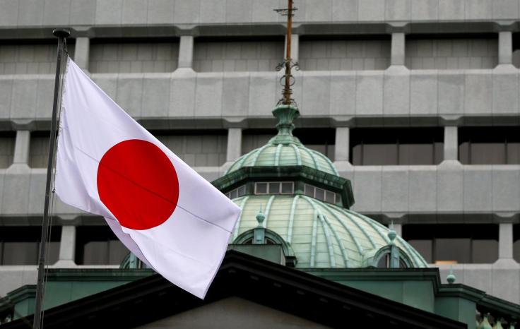 A Japanese flag flutters atop the Bank of Japan building in Tokyo